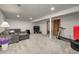 Spacious finished basement with neutral colors, a gray sectional, and exercise equipment at 1487 Brook Mill Ct, Carmel, IN 46032