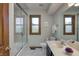 Well-lit bathroom with tile floors, framed mirror, and shower with glass door and tile surround at 1487 Brook Mill Ct, Carmel, IN 46032