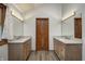Bright bathroom featuring double vanities, modern fixtures, and vinyl flooring at 1487 Brook Mill Ct, Carmel, IN 46032