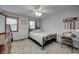 Cozy bedroom features natural light, neutral tones, and a ceiling fan for added comfort at 1487 Brook Mill Ct, Carmel, IN 46032