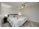 Neutral bedroom features a ceiling fan, side tables and a queen-sized bed with throw blanket at 1487 Brook Mill Ct, Carmel, IN 46032