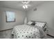 Comfortable bedroom features a ceiling fan, a window with blinds and a patterned bedspread at 1487 Brook Mill Ct, Carmel, IN 46032