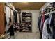Walk-in closet with built-in wooden shelving and storage for your wardrobe at 1487 Brook Mill Ct, Carmel, IN 46032