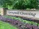 Elegant stone community sign with beautiful landscaping, welcoming residents and visitors to Springmill Crossing at 1487 Brook Mill Ct, Carmel, IN 46032