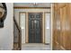 Welcoming entryway featuring a black front door, wood trim, and luxury vinyl plank flooring at 1487 Brook Mill Ct, Carmel, IN 46032