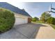 Attached two-car garage and an extended driveway alongside a basketball hoop, providing convenience and recreation at 1487 Brook Mill Ct, Carmel, IN 46032