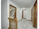 Hallway featuring carpet, wood trim, and open doorway views of the bedrooms at 1487 Brook Mill Ct, Carmel, IN 46032
