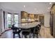 A modern kitchen with granite countertops, stainless steel appliances, and ample counter seating around a large island at 1487 Brook Mill Ct, Carmel, IN 46032