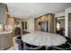 Open kitchen features a spacious island with seating, stone backsplash, and stainless steel appliances at 1487 Brook Mill Ct, Carmel, IN 46032