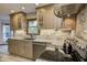 Updated kitchen features granite countertops, modern appliances, a decorative stone backsplash, and ample cabinet space at 1487 Brook Mill Ct, Carmel, IN 46032