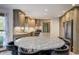 An open kitchen featuring a spacious island with seating, stone backsplash, and stainless steel appliances at 1487 Brook Mill Ct, Carmel, IN 46032