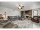 Spacious living room with a brick fireplace, ceiling fan, and luxury vinyl plank flooring at 1487 Brook Mill Ct, Carmel, IN 46032