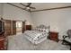 Comfortable bedroom featuring vaulted ceiling, fan, furnishings and neutral-toned carpet at 1487 Brook Mill Ct, Carmel, IN 46032