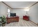 Well-lit home office featuring wood trim, luxury vinyl plank flooring, and modern furnishings at 1487 Brook Mill Ct, Carmel, IN 46032