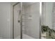This bathroom features a shower with a glass door, handheld shower head, and built-in storage at 1487 Brook Mill Ct, Carmel, IN 46032