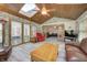 Bright sunroom features wood-paneled ceiling, skylights, and multiple windows offering natural light to the seating area at 1487 Brook Mill Ct, Carmel, IN 46032