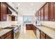 Bright kitchen with stainless steel appliances, wood cabinets, and granite countertops at 350 N Meridian St # 901, Indianapolis, IN 46204