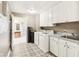 Laundry room features tile floors, ample cabinetry, sink, and washer/dryer at 350 N Meridian St # 901, Indianapolis, IN 46204