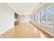 Spacious living room featuring hardwood floors, large windows and custom built-in shelving at 350 N Meridian St # 901, Indianapolis, IN 46204