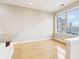 Bright living area features hardwood floors and large windows, framing beautiful cityscape views at 350 N Meridian St # 901, Indianapolis, IN 46204