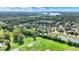 Aerial view of homes in a quiet neighborhood with lush green trees and a pond at 11419 Romeo Pl, Fishers, IN 46040
