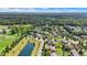 Neighborhood view showcasing a two story house near a pond and park at 11419 Romeo Pl, Fishers, IN 46040