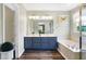 Modern bathroom with double vanity, soaking tub, and separate shower at 11419 Romeo Pl, Fishers, IN 46040