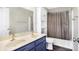 Bathroom with a double vanity, shower/tub combo, and neutral tile at 11419 Romeo Pl, Fishers, IN 46040