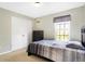 Simple bedroom with double doors, dresser, and striped bedding at 11419 Romeo Pl, Fishers, IN 46040
