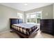 Bright bedroom with a double bed, dresser, and large window at 11419 Romeo Pl, Fishers, IN 46040