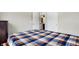 Spacious bedroom with a plaid bedspread and access to a bathroom at 11419 Romeo Pl, Fishers, IN 46040