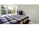 Well-lit bedroom featuring a bed and dresser, overlooking a treetop view at 11419 Romeo Pl, Fishers, IN 46040
