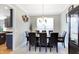 Formal dining room with dark wood table and chairs, and kitchen view at 11419 Romeo Pl, Fishers, IN 46040