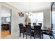Bright dining room with chandelier, and seating for six at 11419 Romeo Pl, Fishers, IN 46040