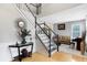 Bright entryway with hardwood floors, staircase, and views to living room at 11419 Romeo Pl, Fishers, IN 46040