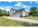 Two-car garage and side view of a charming brick home at 11419 Romeo Pl, Fishers, IN 46040
