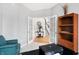 Home office with built-in shelving, and view to entryway at 11419 Romeo Pl, Fishers, IN 46040