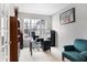 Home office features a large window, built-in shelving, and comfortable seating at 11419 Romeo Pl, Fishers, IN 46040
