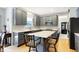 Gray kitchen cabinets, quartz countertops, and kitchen island with seating at 11419 Romeo Pl, Fishers, IN 46040