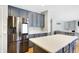 Stainless steel refrigerator and kitchen island with white countertop at 11419 Romeo Pl, Fishers, IN 46040
