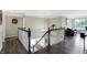 Spacious landing overlooks living area, with dark hardwood floors and neutral wall colors at 11419 Romeo Pl, Fishers, IN 46040