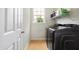 Laundry room with washer, dryer, and overhead shelving at 11419 Romeo Pl, Fishers, IN 46040