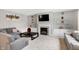 Living room features a sectional sofa and a gas fireplace at 11419 Romeo Pl, Fishers, IN 46040