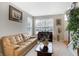 Living room with comfortable seating, large windows, and a view of the entryway at 11419 Romeo Pl, Fishers, IN 46040