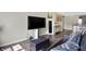 Cozy sitting area with black leather couch, large TV, and storage ottoman at 11419 Romeo Pl, Fishers, IN 46040