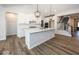 Open concept kitchen boasts a large island, white cabinets and stainless steel appliances at 18862 Shefler Blvd, Noblesville, IN 46062