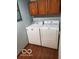 Efficient laundry area with washer, dryer, and overhead cabinets at 1322 Greenway Dr, Anderson, IN 46011