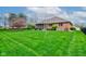 Lovely backyard with a mix of green grass and mature trees, perfect for outdoor enjoyment at 691 Walnut Woods Dr, Greenwood, IN 46142