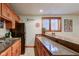 Finished basement bar area features seating, cabinets, and a refrigerator at 691 Walnut Woods Dr, Greenwood, IN 46142