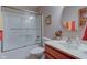 Well-lit bathroom with a shower-tub, framed art, and a cherry-wood cabinet at 691 Walnut Woods Dr, Greenwood, IN 46142